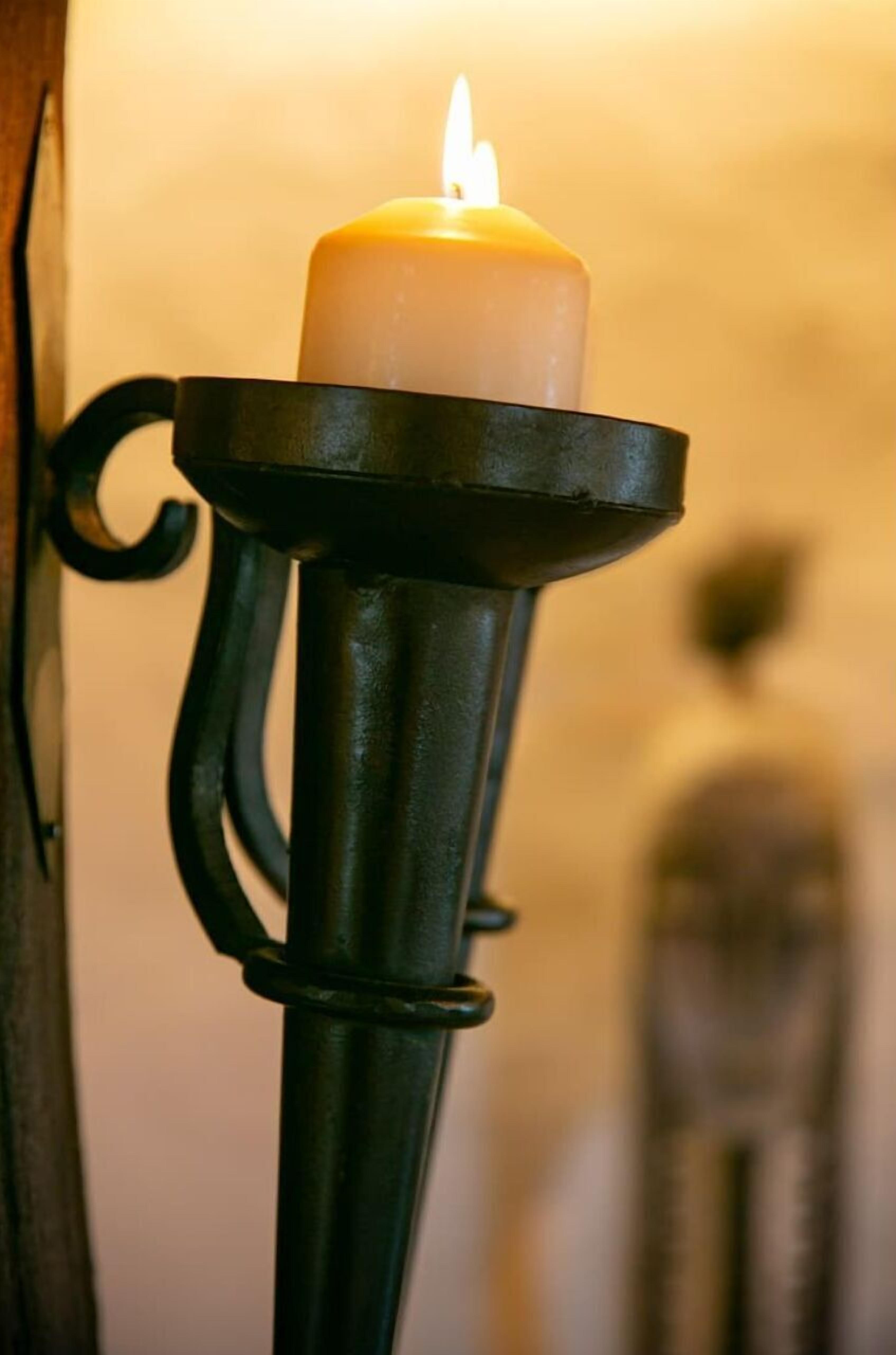 A candle in a metal holder.