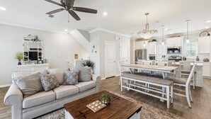 A modern living room with a sofa, coffee table, and a ceiling fan. - NEW LISTING! Lost Key Golf & Beach Club~ Happy Ours -  NO HASSLE CHECK OUT (Pensacola)