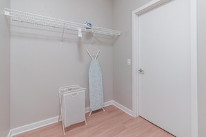 Convenient laundry area with a drying rack and stand for your needs.