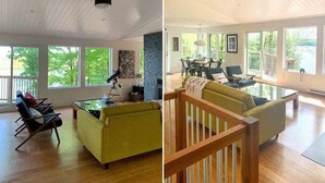 A spacious living room with a large window, a ceiling fan, and a dining area with a view of the outdoors. - Lakeview Retreat - Three Bedroom Cottage, Sleeps 6 (Kinmount)