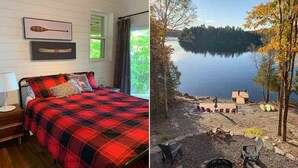 A bedroom with a plaid bedspread, a canoe on the wall, and a view of a lake. - Lakeview Retreat - Three Bedroom Cottage, Sleeps 6 (Kinmount)