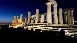 Ancient ruins with columns and a stone structure at night. - The terrace by the sea (Sciacca)