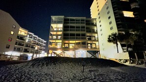 A multi-story hotel with balconies and a beach in the foreground. - 3 Bedroom Condo on the beach. (Murrells Inlet)