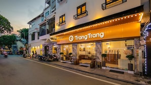 A hotel with a prominent entrance, outdoor seating area, and a well-lit facade. - TrangTrang Classy Hotel (Hanoi)