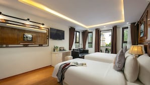A hotel room with two beds, a desk, a TV, and a view of the outside. - TrangTrang Classy Hotel (Hanoi)