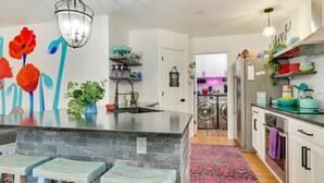 A modern kitchen with a central island, bar stools, a washing machine, and a refrigerator. - Contemporary Home - 1 Mi to Georgetown Square (Georgetown)