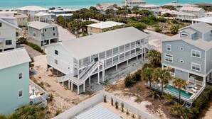 A coastal residential area with multiple houses, some with balconies and a pool area visible. - Grayton Beach Villas 101 - Scenic 30A, Steps to the Sand, Walk to Red Bar! (Grayton Beach)