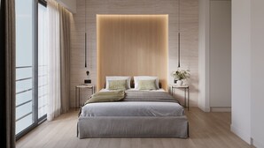 Une chambre moderne avec un grand lit, des tables de chevet, une commode et une fenêtre avec des rideaux.