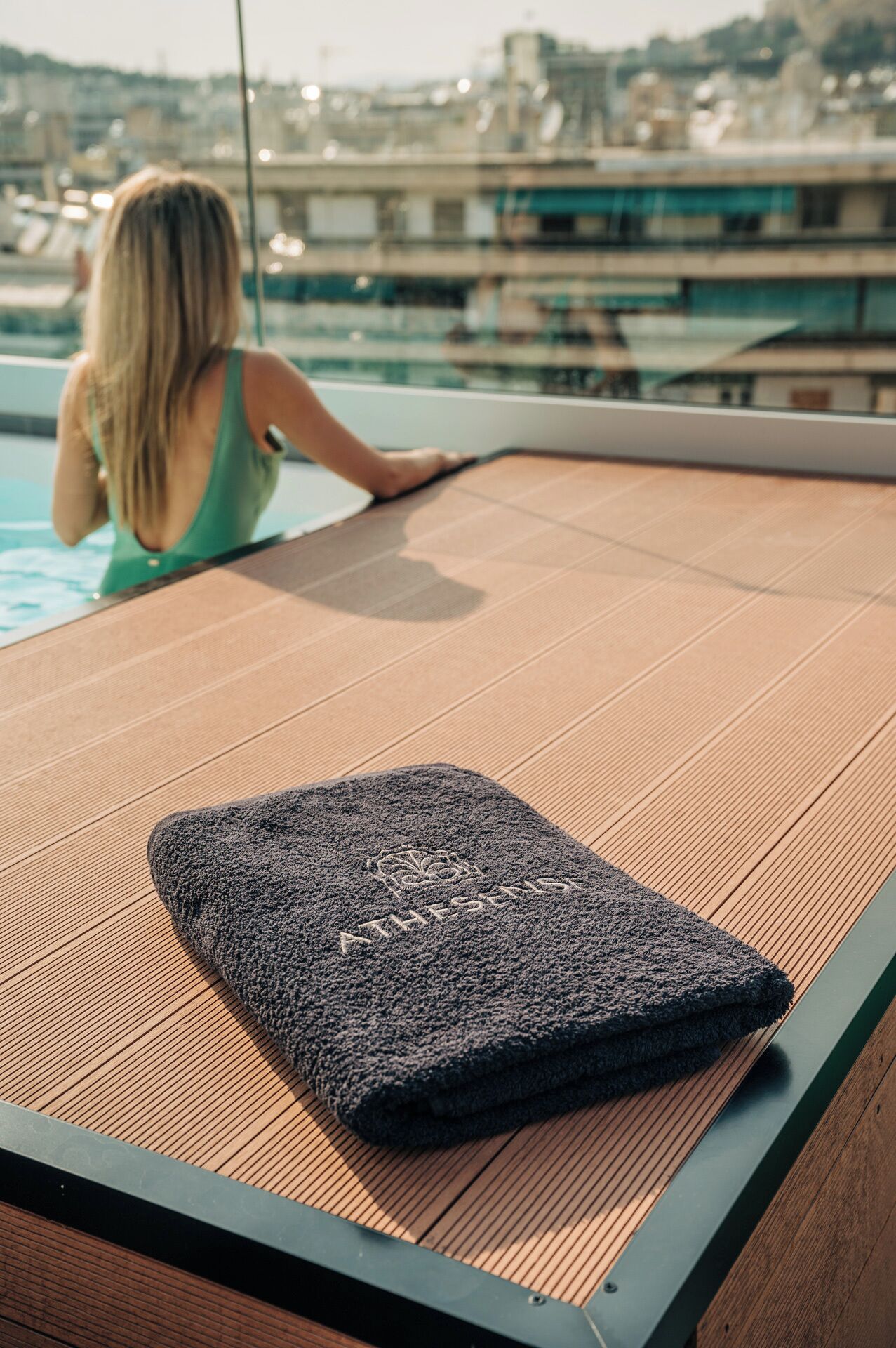 A poolside area with a lounge chair and a towel.