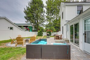 A backyard with a swimming pool, outdoor furniture, and a covered patio area. - Downtown Retreat w/ Grill, Fire Pit & Wet Bar (Lake George)