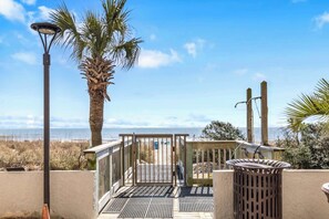 Enjoy a beachfront retreat with a covered patio featuring a grill and ocean views.