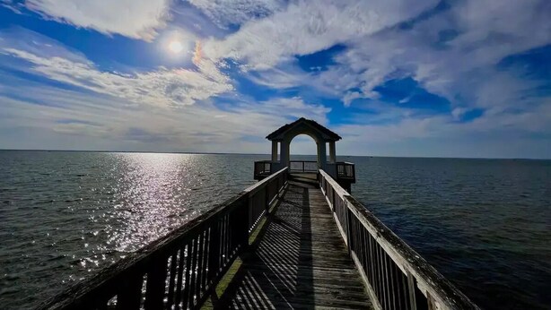 A wooden pier leading to a gazebo over the water. - Beach House (Corolla)