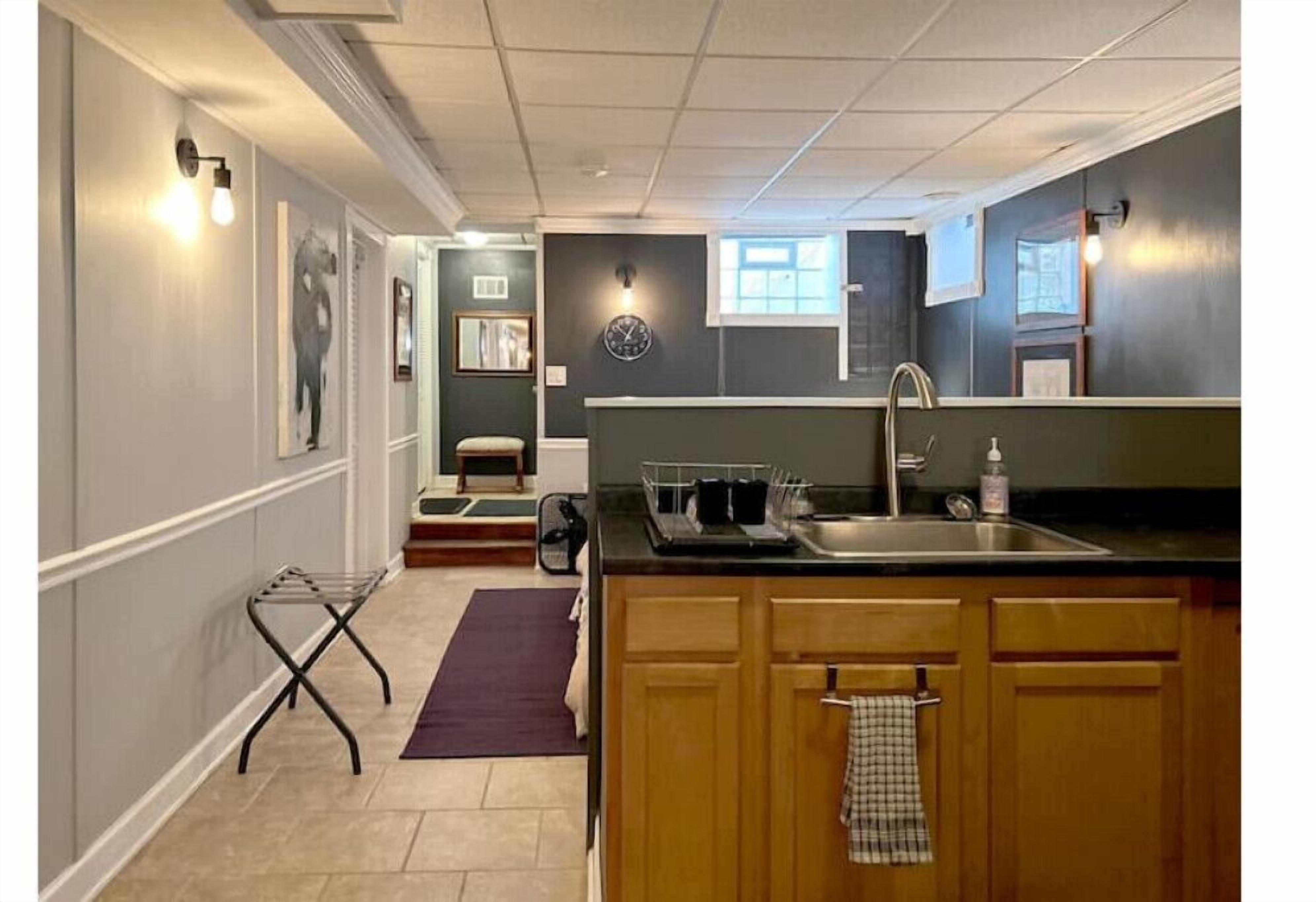 A compact kitchen with wooden cabinets, a built-in sink, and a small window.