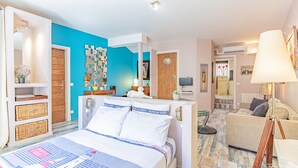 Une chambre à coucher avec un lit, une commode, une chaise et une lampe.