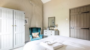 A bedroom with a large bed, a dresser, a chair, and two wardrobes. - Cuckoo (Bakewell)
