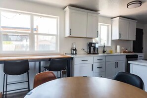 Enjoy cooking in this well-equipped kitchen with a stove, coffee maker, and sink.