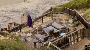 A beach with a wooden deck, lounge chairs, and a small pool. - Quiet Townhome with Ocean View (Solana Beach)