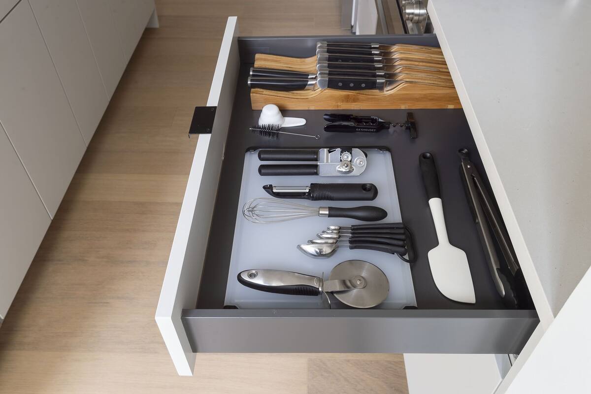 A kitchen drawer with various utensils and tools neatly organized.