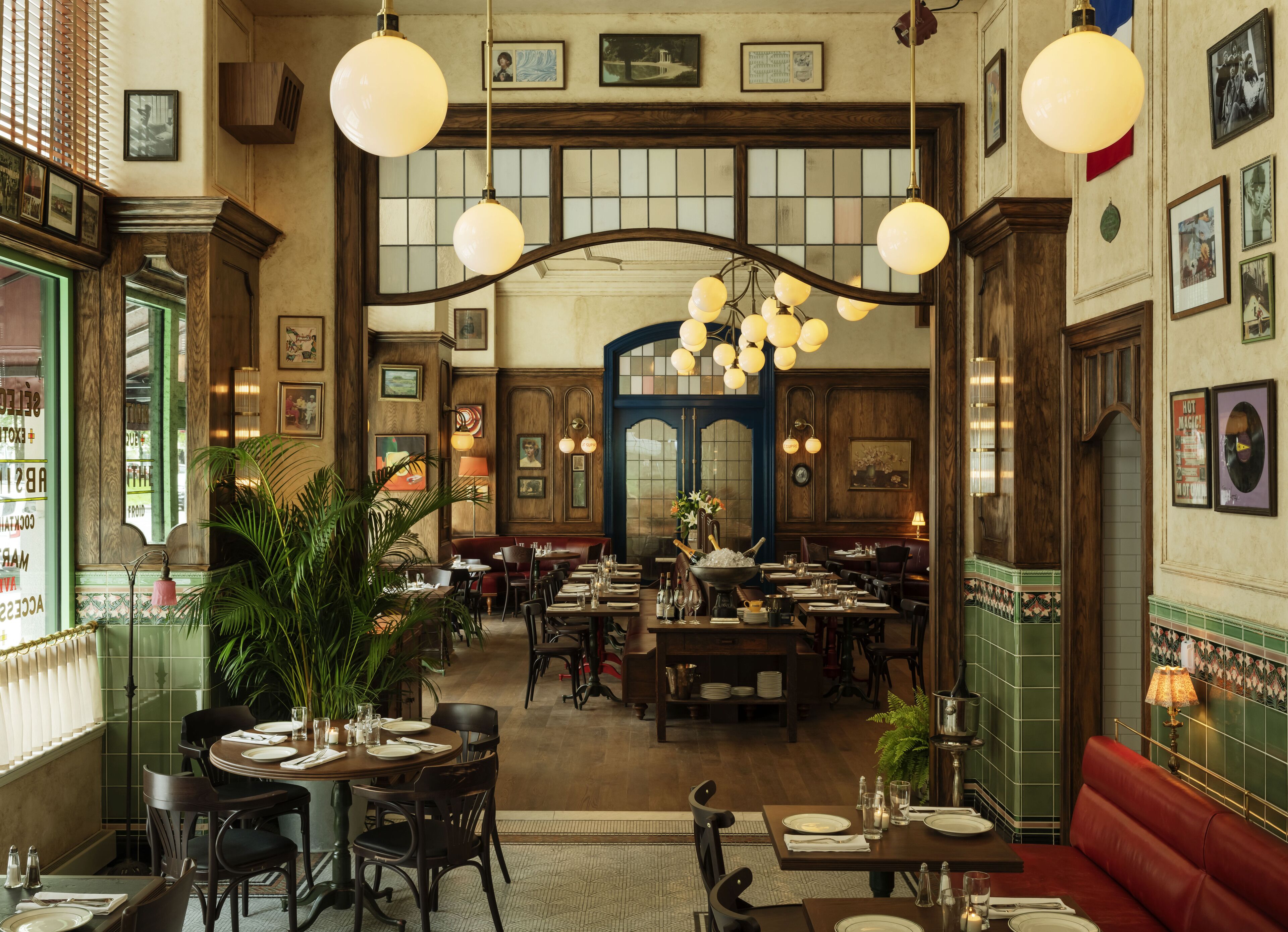 A spacious restaurant with high ceilings, wooden beams, and multiple dining tables and booths.