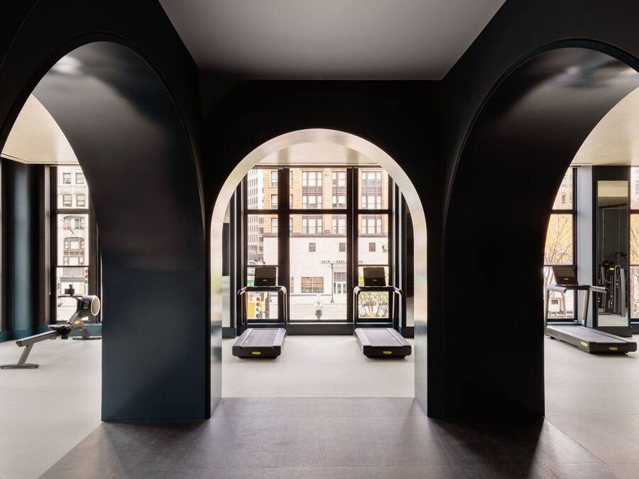 A modern gym with large windows and a minimalist design.