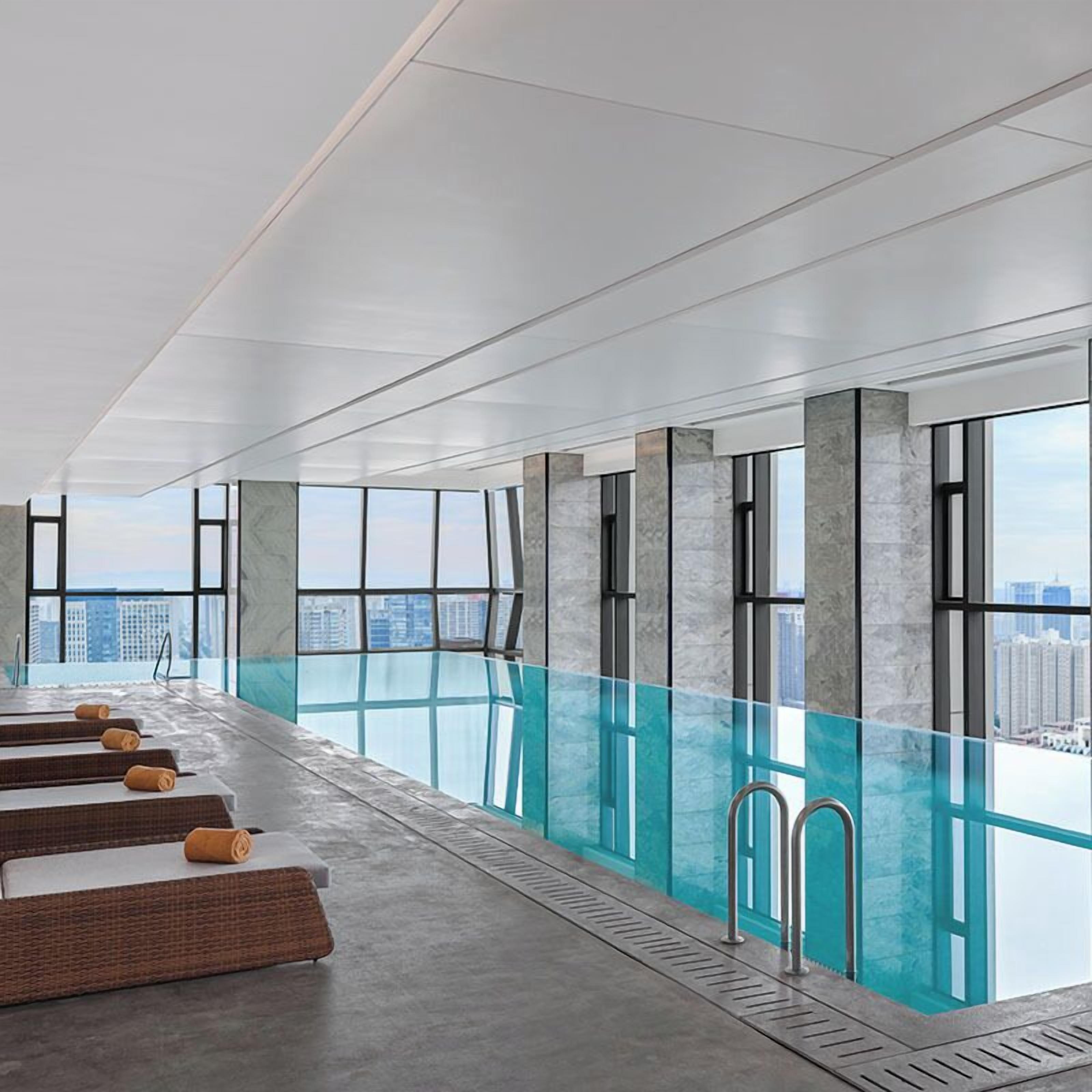 Indoor pool, open 10:00 AM to 10:00 PM, pool loungers