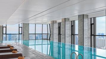 Indoor pool, open 10:00 AM to 10:00 PM, pool loungers