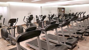 A gym with multiple treadmills and elliptical machines arranged in rows. - Two Beautiful 1 BR apts, 2 floors apart HS WiFi, full amenities! (Ciudad de México)