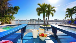 Zona junto a la piscina con una mesa, sillas y vistas a la piscina.