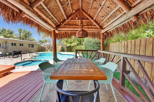 Kick back and get vacation ready! Shaded tiki hut with pool views and BBQ