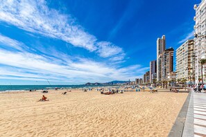 A beach with high-rise buildings, sandy beach, and clear blue sky. - VIRGINIA sea view apartments (Benidorm)