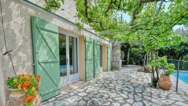 A stone-paved patio with a pool, green shutters, and potted plants. - SERENITY Villa for 8 By Sunset (Grasse)