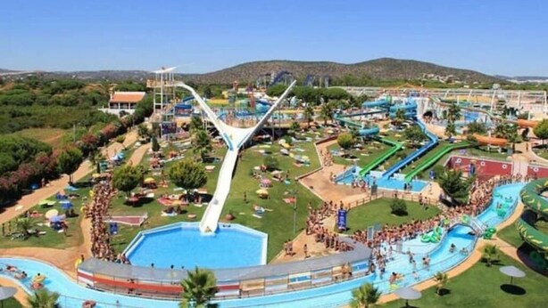 A water park with a large pool, multiple slides, and a bridge structure. - Modern 2 bedroom Vilamoura Marin (Quarteira)