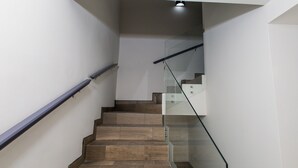 A modern staircase with wooden steps and glass railings. - Residence 4 (4 Bed 3.5 Bath By FMI Rentals) (Puerto Peñasco)