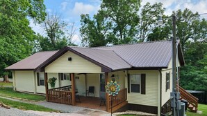 A two-story house with a porch, a covered patio, and a small staircase leading to the upper level. - Cottage at Lake Cumberland; 6m walk to water at Clearwater public boat ramp (Nancy)