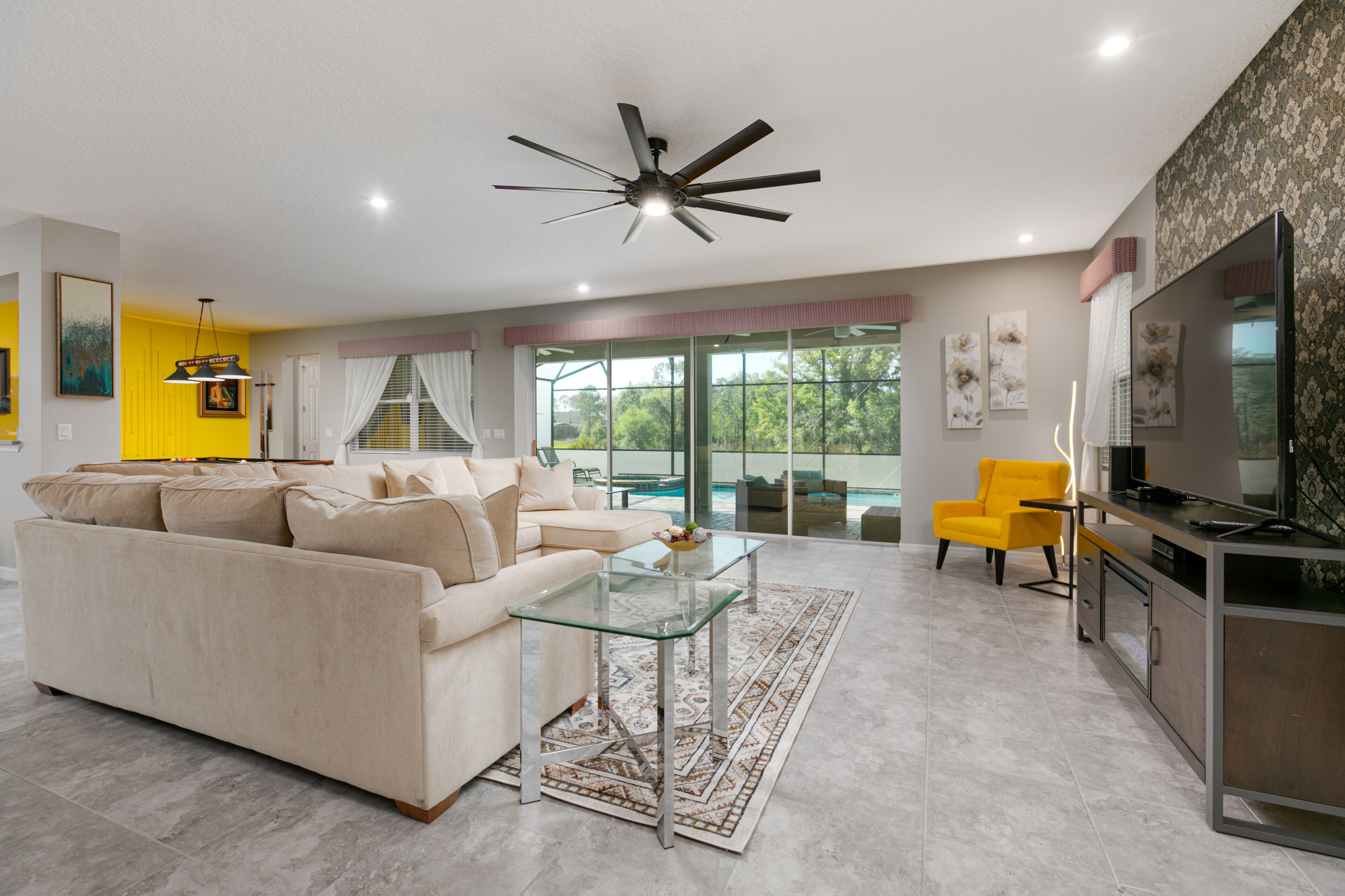downstairs living area with view of pool/patio