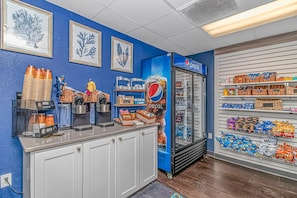 A coffee station with Keurig machines, a Pepsi refrigerator, and snack shelves. - Ocean Reef 1503 (Myrtle Beach)