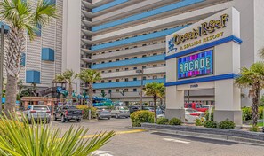A multi-story hotel with a sign for Ocean Reef A Seaside Resort and Arcade. - Ocean Reef 1503 (Myrtle Beach)