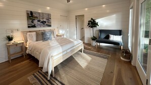 A bedroom with a bed, bedside tables, a nightstand, a window, a plant, and a ceiling fan. - Beautiful and relaxing Golf & Lake retreat waiting just for you!!  (Hot Springs Village)