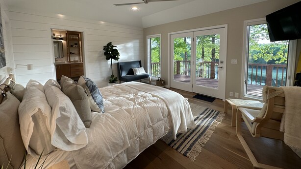 A bedroom with a large bed, a ceiling fan, a TV, and a view of a deck. - Beautiful and relaxing Golf & Lake retreat waiting just for you!!  (Hot Springs Village)
