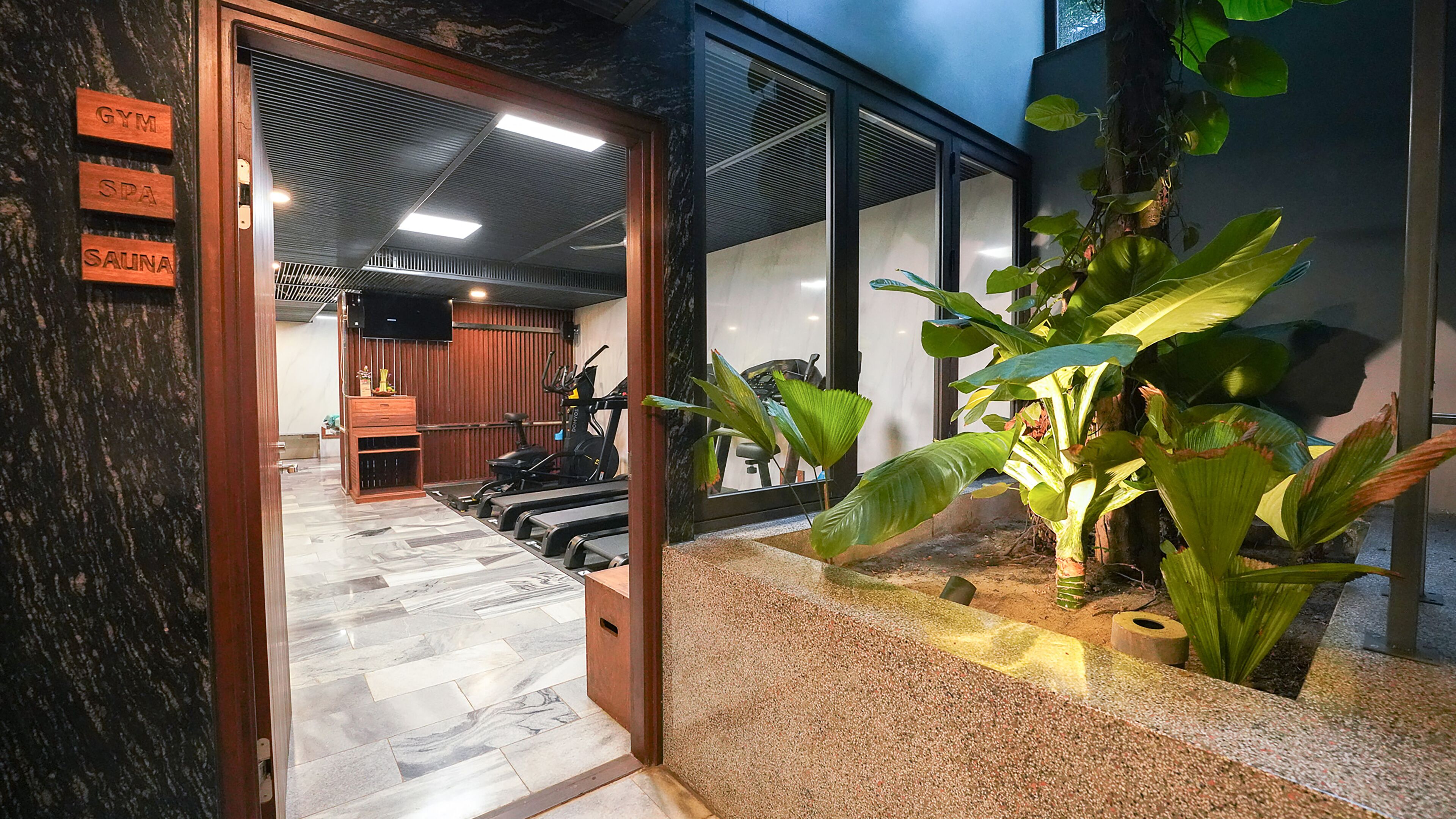 A gym area with exercise equipment, a spa, and a sauna.