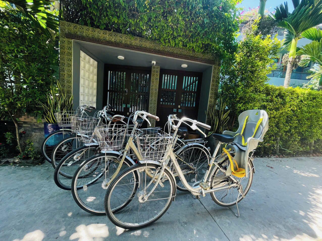 A row of bicycles parked outside a building with a decorative entrance.