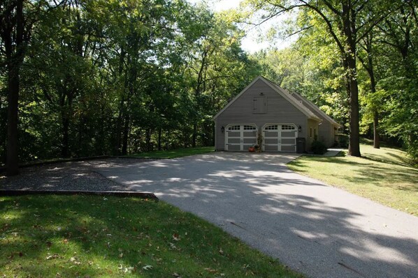 A single-story house with a garage, surrounded by trees and a driveway. - Beautiful Private Setting !!! (Bristol)