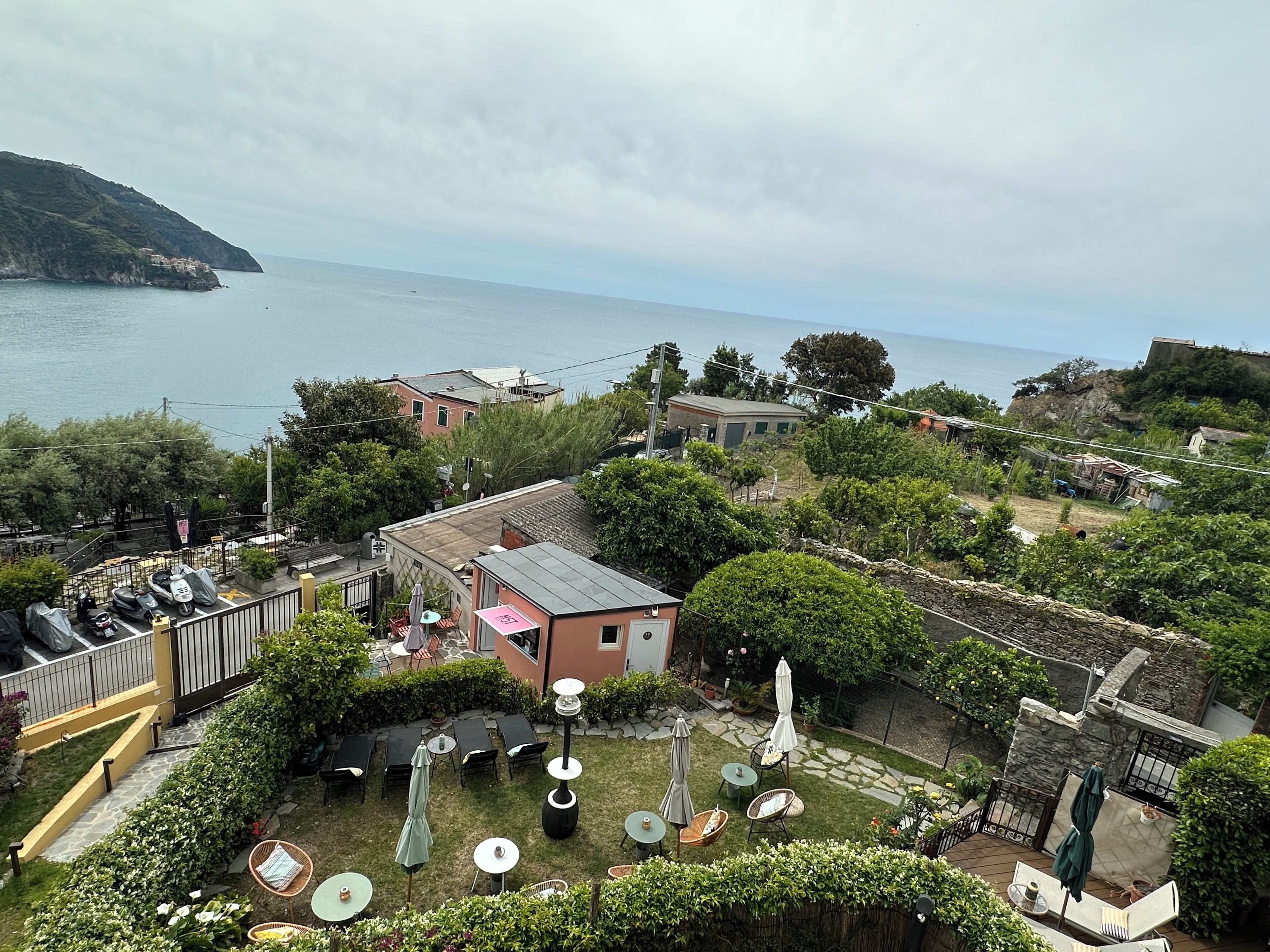A coastal property with a patio area, outdoor seating, and a view of the sea.