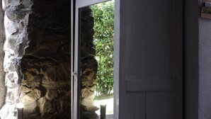 A stone wall with a door leading to a bright outdoor area. - Madüneta 5 Terre Guesthouse (Vernazza)