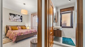 A bedroom with a bed, bedside table, and a window. - Holiday Home "Ca' Alessandra" with Private Terrace and Air Conditioning (Carloforte)
