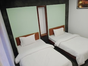 A room with two single beds, each with a wooden headboard and white bedding. - Shalima Guest House (Siem Reap)