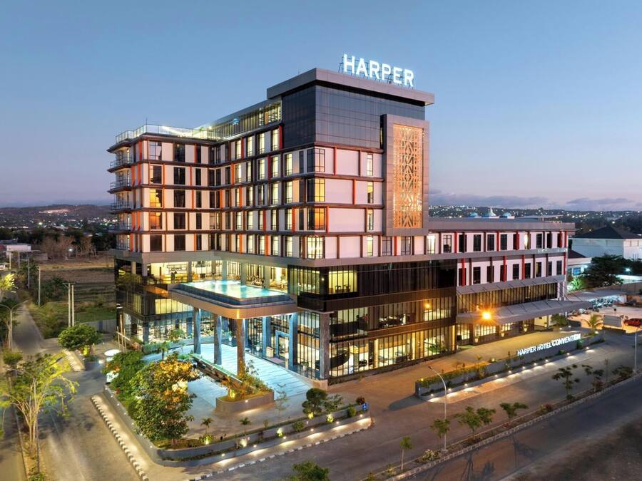 A multi-story hotel with a modern design, featuring a rooftop pool and a prominent 'Harper' sign.