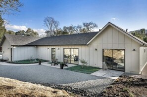 Enjoy a comfortable stay in this single-story building with a covered patio and garden, featuring a large sliding glass door entrance.