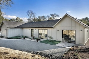 Enjoy a comfortable stay in this single-story building with a covered patio and garden, featuring a large sliding glass door entrance.