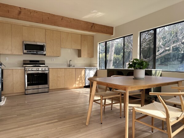 Enjoy meals in the kitchen with a dining area and large windows offering a view of the outdoors.